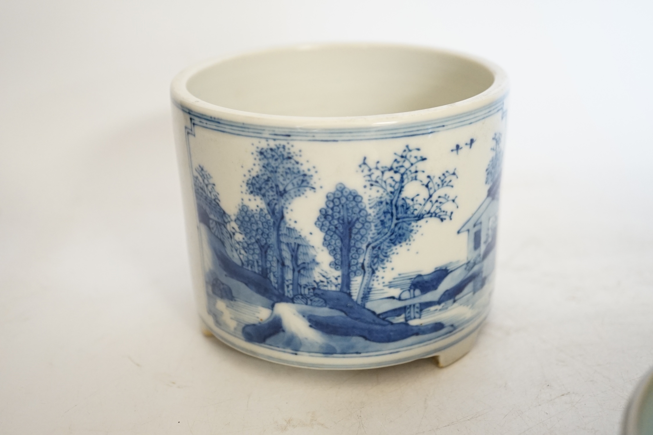 A Chinese blue and white footed brush pot and celadon glazed ‘fish’ bowl, tallest 9cm. Condition - good